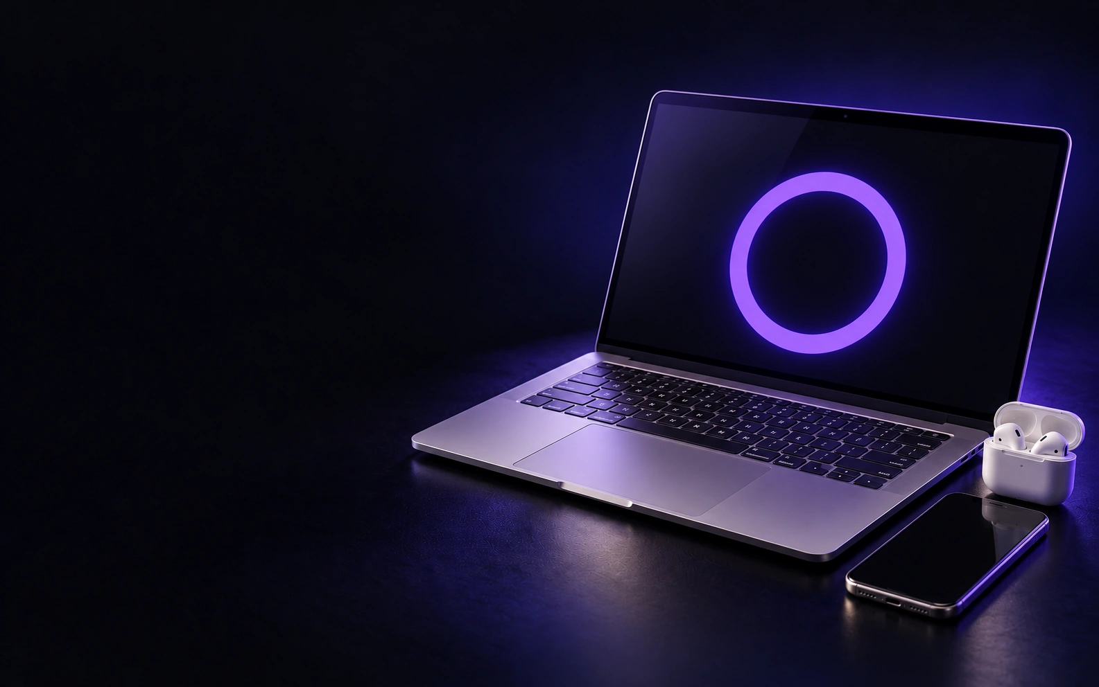 An open laptop with a glowing violet ring on screen, a phone and wireless earbuds on a dark studio surface.