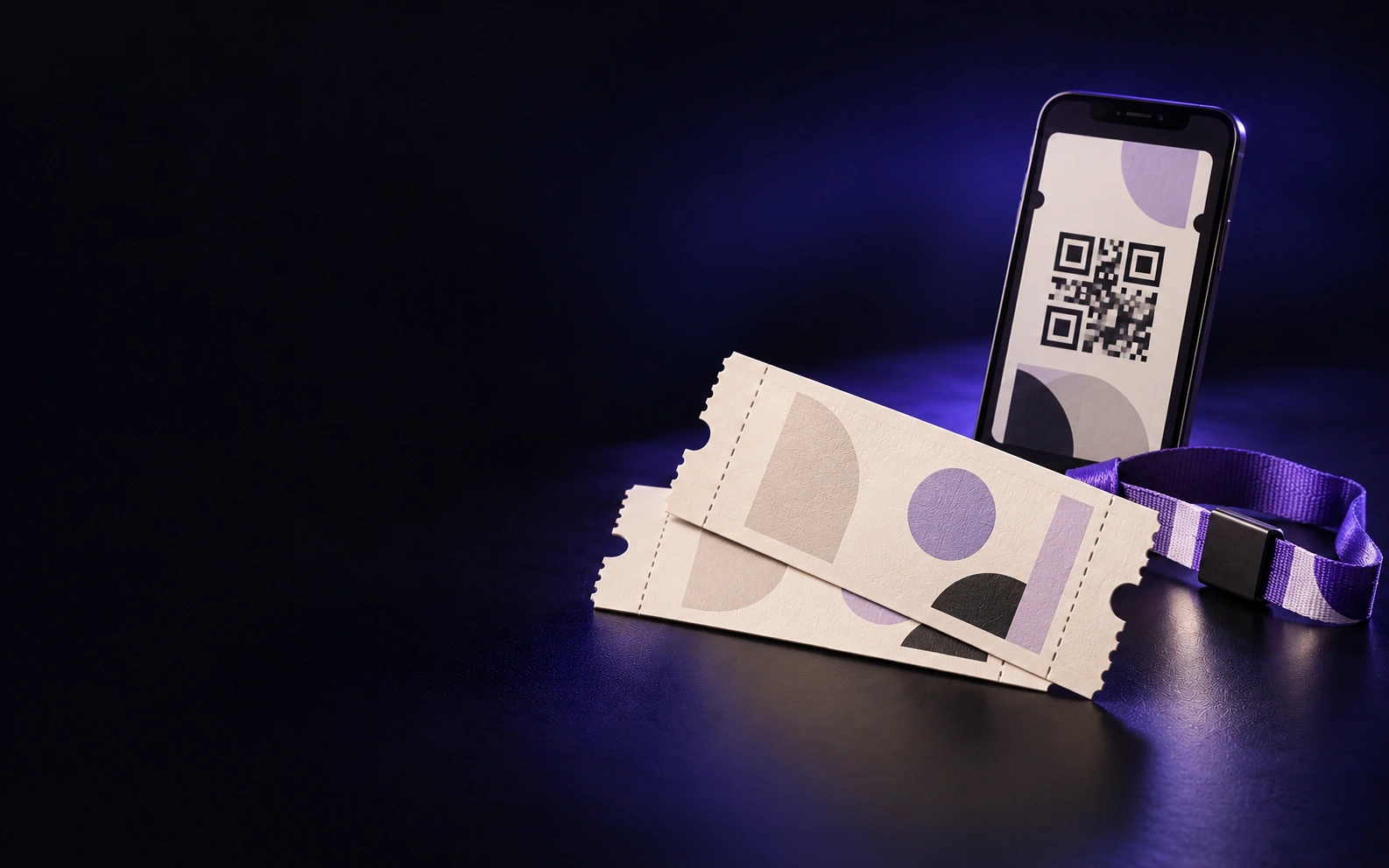 Two paper tickets, a phone showing a QR ticket and a festival wristband on a dark studio surface.